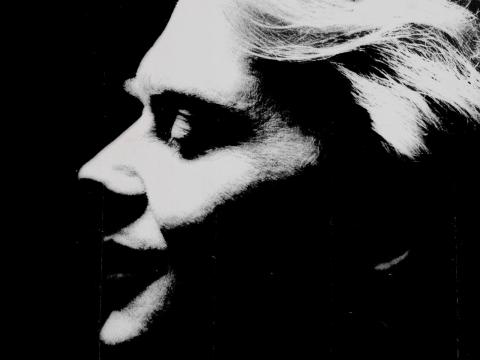 Close up of John Farnham in profile with eyes closed in a stylised black and white image for his album cover Whispering Jack.