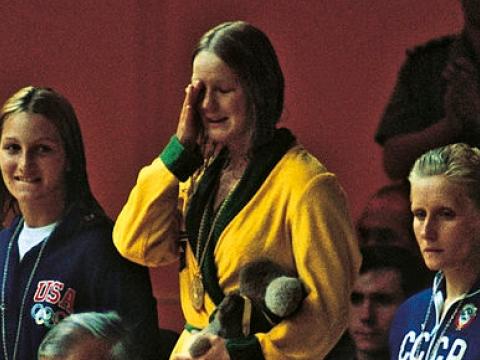 Beverley Whitfield on the podium crying after receiving the gold medal