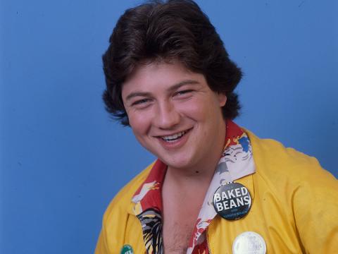 Jonathan Coleman wearing a yellow jacket, smiling at camera.