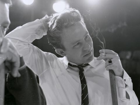 Johnny O'Keefe close up, smoking with broom in hand