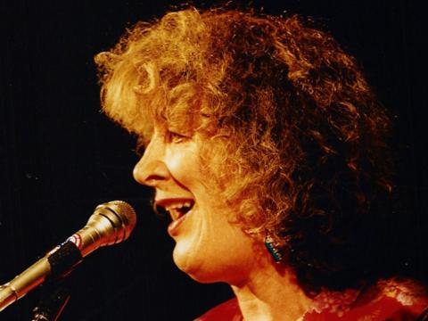 Close up of Margret RoadKnight in profile singing.