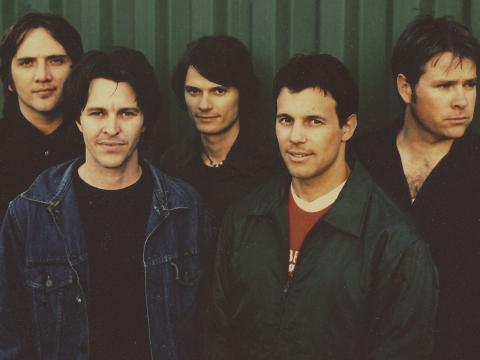 Photo of the five members of the band Powderfinger.