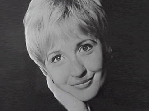 Amber Mae Cecil headshot with short blonde hair