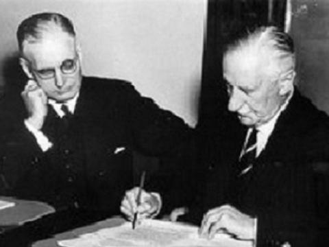 John Curtin and another man seated at a table.