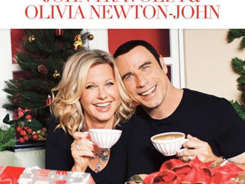 Album cover featuring Olivia Newton-John and John Travolta. They are holding cups aloft. The text reads 'This Christmas - John Travolta and Olivia Newton-John'.