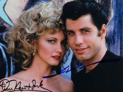 Signed portrait photo of Olivia Newton-John and John Travolta from the movie Grease.