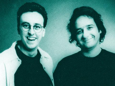 Tony Martin and Mick Molloy pictured from the chest up, smiling directly at camera