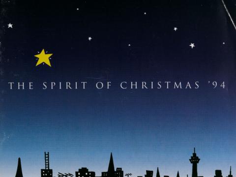 An album cover depicting a city skyline and night sky. The text reads 'The Spirit of Christmas '94'.