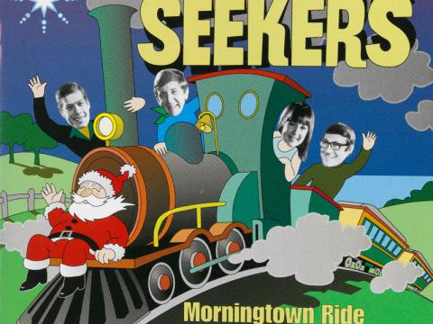 An album cover showing an illustration of Santa on a train with The Seeker's heads on top of the illustration. Text reads 'The Seekers: Morningtown Ride to Christmas'.