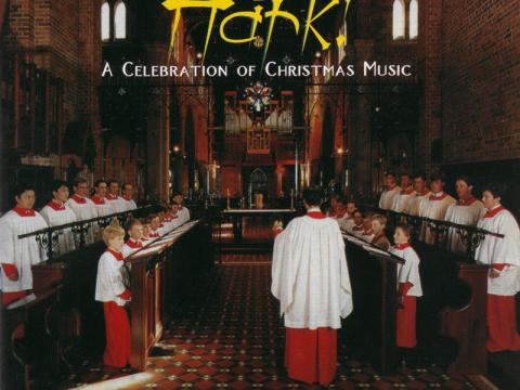 An album cover with a photograph of a choir performing in a church.