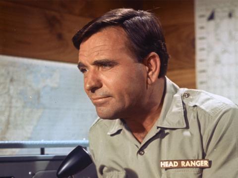 Ed Devereaux wearing his Head Ranger costume speaking into a radio.