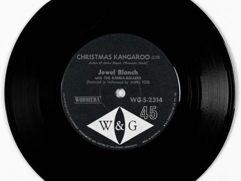 A vinyl record with a black and white label. The label text says 'Christmas Kangaroo' by 'Jewel Blanch with the Kanga-Rollers'