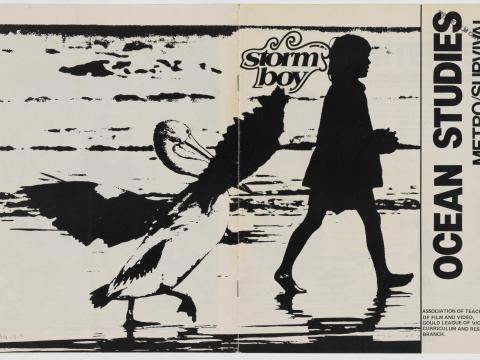 Black and white cover of the Ocean Studies guide to Storm Boy. Features image of Storm Boy (Greg Rowe) in silhouette walking along the beach with Mr Percival the pelican following after him 