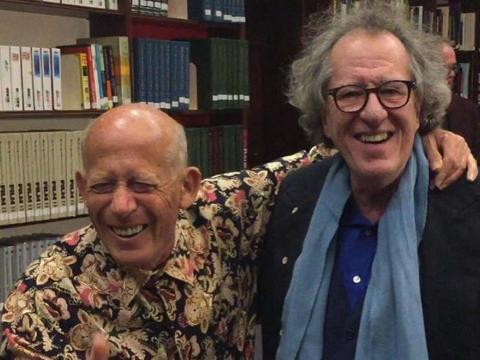 Pianist David Helfgott has his arm around actor Geoffrey Rush's neck and is giving a thumbs up sign and laughing