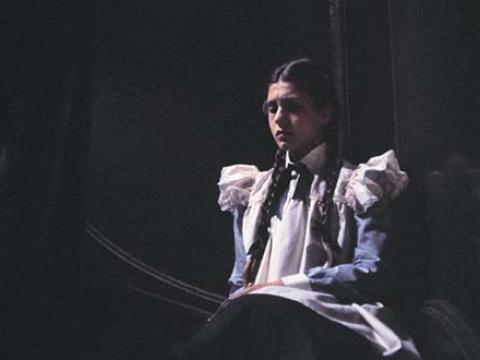 Orphan Sara Waybourne seated on the steps in Appleyard College in a scene from Picnic at Hanging Rock