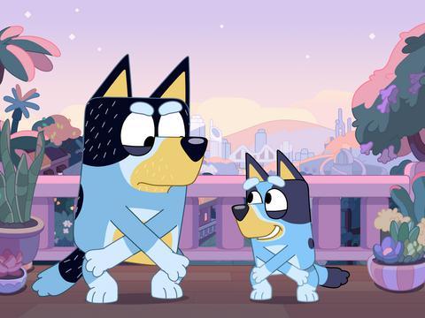 Animated still of two blue heeler dogs dancing in the twilight with the skyline of Brisbane City in the background.