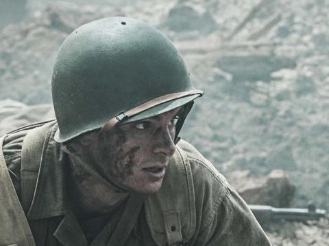 Andrew Garfield in Second World War uniform about to rescue a wounded soldier in Hacksaw Ridge