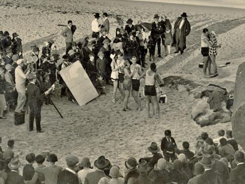 A group of men and women at Sydney's Tamarama beach filming a party scene for the film Those Who Love (1926)