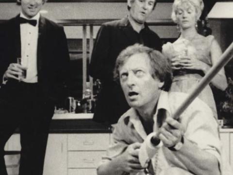 Don (John Hargreaves), Mal (Ray Barrett), Jody (Veronica Lang) and Mack (Graham Kennedy) crouching holding a broom as a guitar