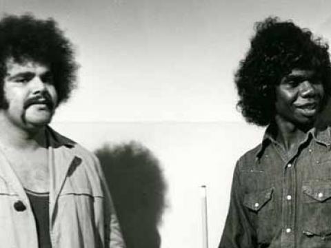 Burt Williams standing with David Gulpilil on the set of Homicide. David is holding a pool cue.