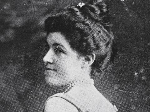 Marie Narelle standing and looking over her shoulder.