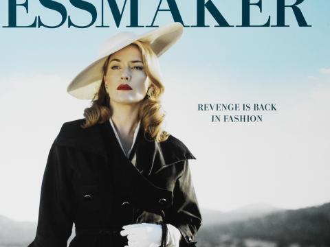 Upper body shot of actress Kate Winslet on a film poster for 'The Dressmaker'. She is wearing a white hat and black coat. There is blue sky in the background and the film title is written above her head.