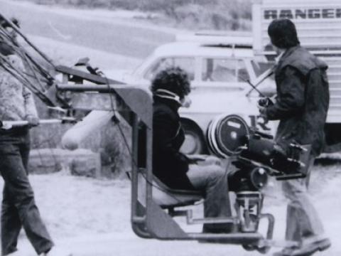 Mad Max 1 production crew. Cameraman on boom.