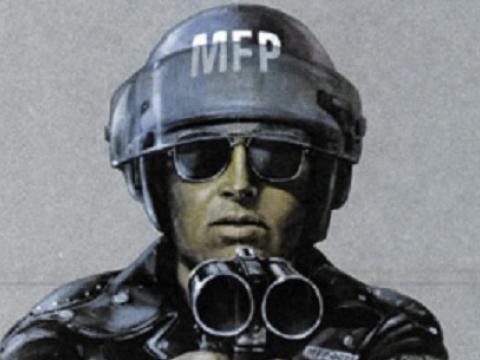 Head and shoulders of a motorcycle policeman pointing a gun.