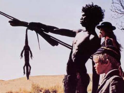 David Gulpilil, Lucien John and Jenny Agutter standing in the desert in a lobby card from Walkabout.