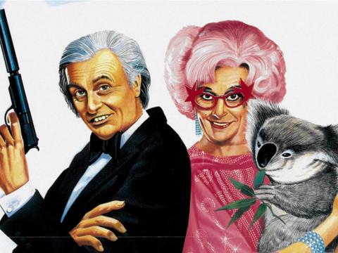Close-up of an illustrated film poster showing Sir Les Patterson in a tuxedo holding a smoking gun and Dame Edna Everage holding a koala.