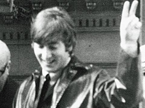 John Lennon waves to crowds in Melbourne, 1964. 