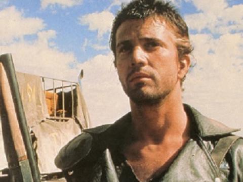Mad Max 2 lobby card featuring Max (Mel Gibson) holding a sawn-off shotgun