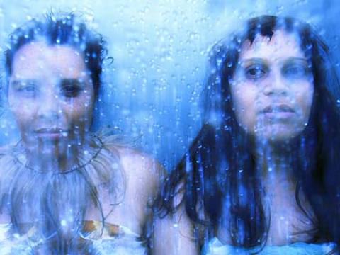 Two women (Nardi Simpson and Kaleena Briggs) standing next to each other, water effect on top.