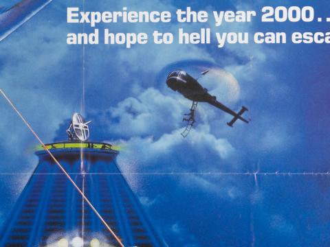 Poster art for the film Escape 2000 showing a skyscraper and a helicopter in the sky. 