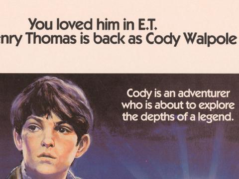 Close up of a young boy's face. Writing above his head says 'You loved him in E.T. Henry Thomas is back as Cody Walpole.' Writing at the side says 'Cody is an adventurer who is about to explore the depths of a legend'.