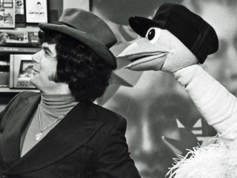Close up of Daryl Somers and Ossie Ostrich on the set of Hey Hey It's Saturday. Both are wearing hats and looking off-camera to their right. 