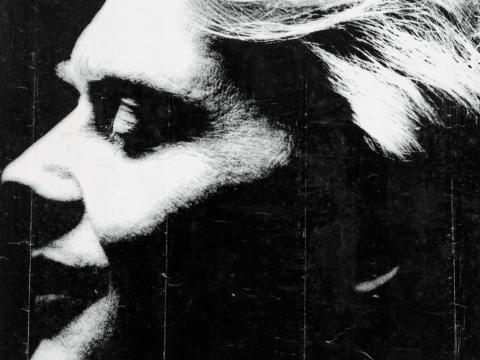 Close up of John Farnham's face in profile on a poster.