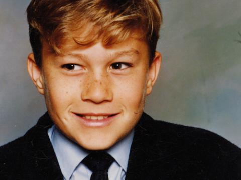 A close-up of Heath Ledger as a school boy wearing a shirt and tie.
