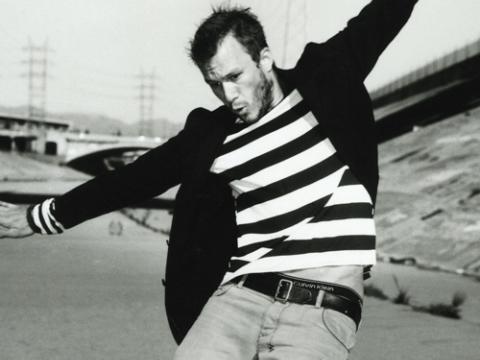 Heath Ledger riding a skateboard.