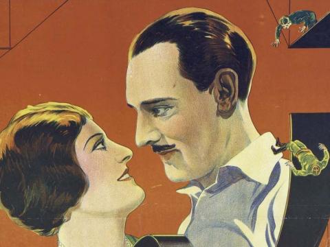 A man and woman gaze lovingly into each other’s eyes in a detail from the 1930 film poster for Looping the Loop