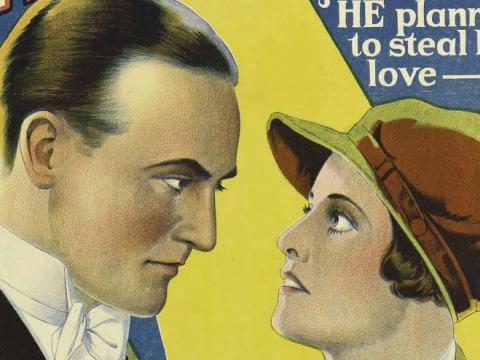 A close-up of a man facing a woman from a 1929 film poster