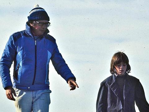 Director Henri Safran talking with actor Greg Rowe as they walk along the beach on the outdoor set of Storm Boy