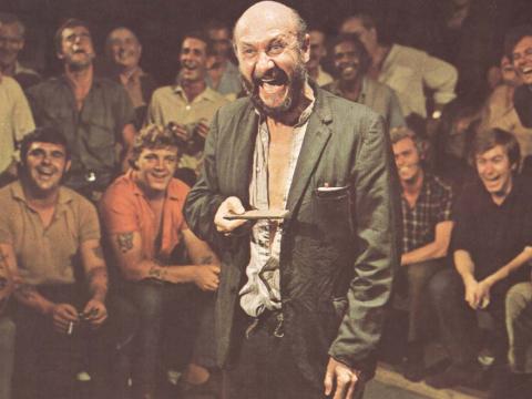 Donald Pleasence laughing during the two-up game scene from the 1971 movie Wake in Fright
