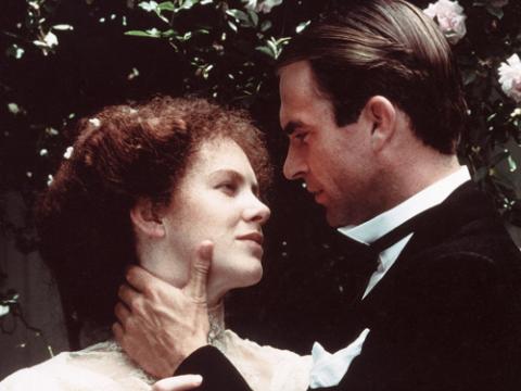 Judy Davis as Sybylla and Sam Neill as Harry embrace. He is touching her neck and she is touching his arm. They look at each other lovingly.