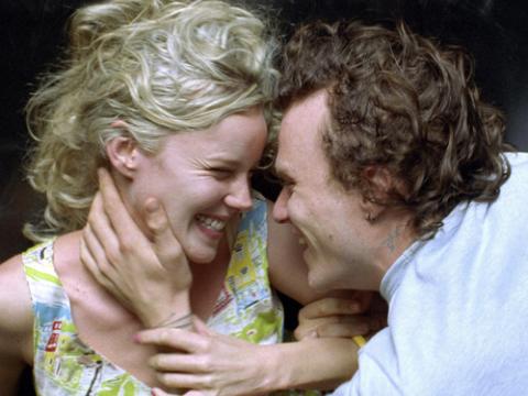 Abbie Cornish as Candy and Heath Ledger as Dan smiling at each other and in an embrace.