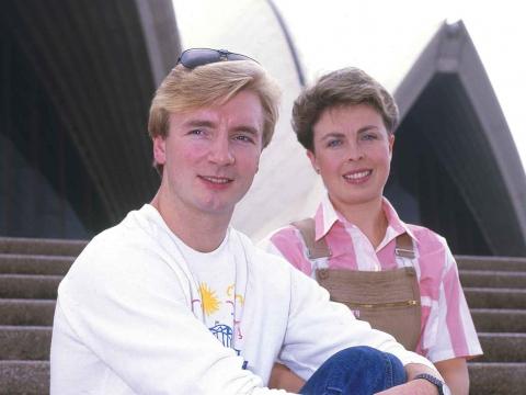Ice skaters Jane Torvill and Christopher Dean posing on the steps of the Sydney Opera House.