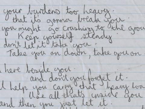 Close-up of handwritten lyrics to the song 'We Won't Cry' by Archie Roach.