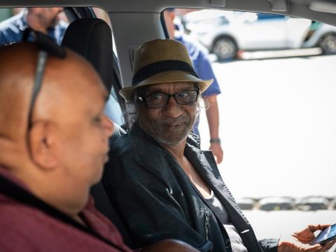 Kutcha Edwards and Bart Willoughby seated in the front of a car