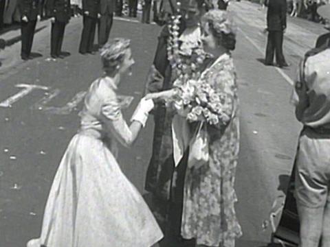 Queen Mother greeted at the Town Hall by a young woman in Melbourne. 1958.