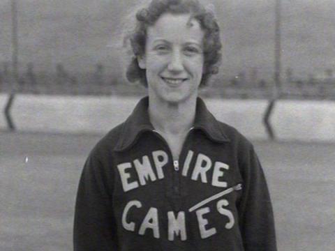 Decima Norman wearing a track suit with the words, 'Empire Games'.